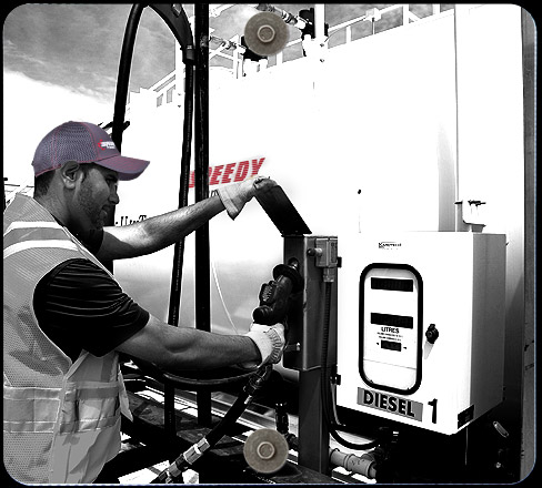 Speedy transport driver refueling truck before shipping